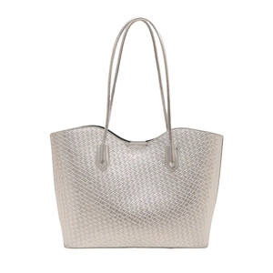 Silver woven tote bag with a metallic finish and elegant wave-shaped top edge