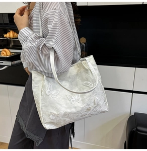 Chic white butterfly embroidered shoulder bag styled in a modern kitchen lifestyle setting