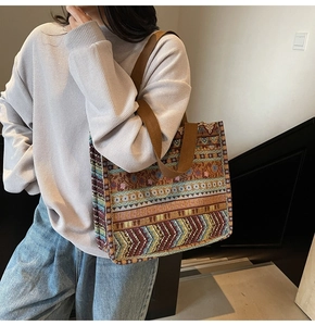 Detail of bohemian tote bag with colorful ethnic jacquard fabric and brown canvas strap