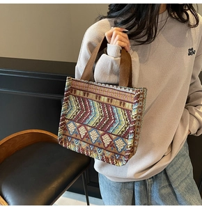 Detail of bohemian tote bag showing jacquard pattern and reinforced brown webbing handles