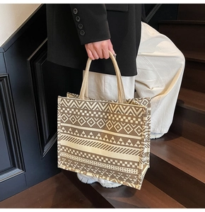 Detailed macro view of high-capacity canvas tote bag with ethnic geometric pattern