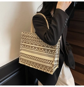 Detailed view of large canvas tote bag with brown and white geometric woven patterns