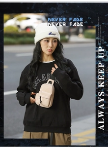 Close-up of beige waterproof shoulder bag worn as a crossbody chest pack by a model