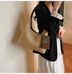 Detail of a beige woven hobo bag with brown leather trim and a detachable small coin pouch