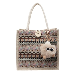 Ethnic bohemian woven tote bag with geometric patterns, white rope handles and eye charm