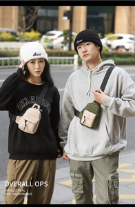 Detail of urban nylon crossbody bags featuring multi-compartment storage and buckle straps