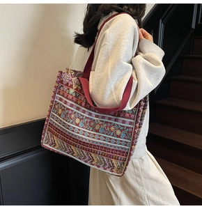 Detail of bohemian jacquard tote bag with ethnic geometric patterns and red canvas straps