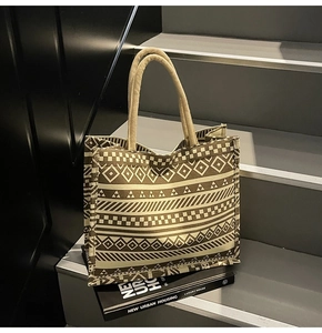 Detail of large canvas tote bag with retro geometric patterns on modern urban stairs