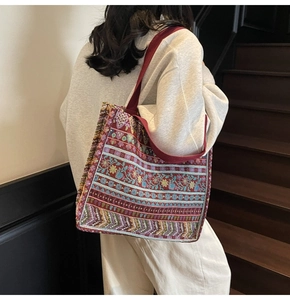 Detail of ethnic tote bag showing red bohemian embroidery and sturdy wide strap