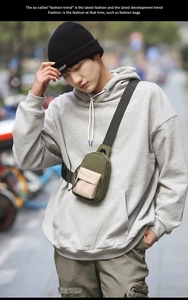 Detail of waterproof nylon mini chest bag in olive green with beige contrast pocket