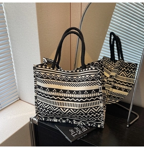 Macro detail of high-capacity tote bag featuring black and white geometric patterns
