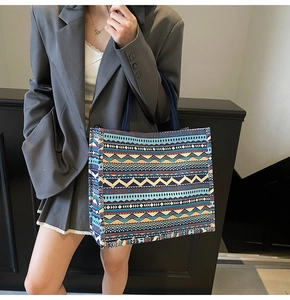 Detail of colorful geometric pattern canvas tote bag styled with casual grey blazer