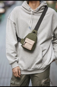 Outdoor leisure crossbody bag in army green and cream white on a street model