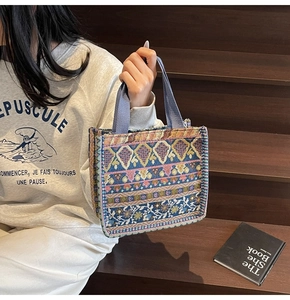 Ethnic bohemian tote bag featuring intricate geometric jacquard and blue woven handle