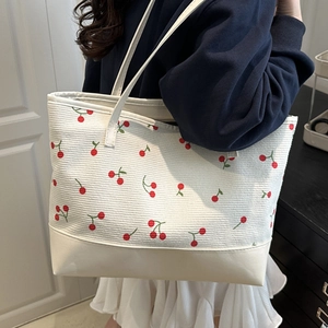 Minimalist white canvas tote bag with cherry print pattern and leather bottom panel