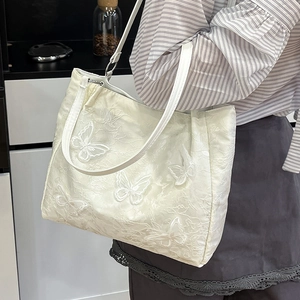 Cream chic pleated underarm tote bag with 3D butterfly embroidery and textured fabric finish