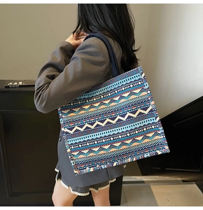 Detailed view of bohemian geometric pattern canvas tote bag with ethnic woven textures