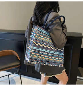 Detail of the large canvas tote bag showing colorful bohemian geometric patterns and rope handles