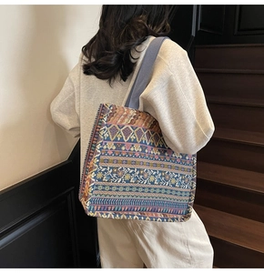 Detail of bohemian tote bag featuring ethnic jacquard patterns and purple woven handles