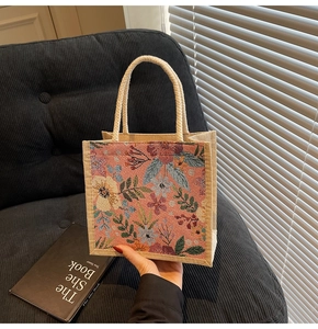 Nahaufnahme der floralen Jacquard-Stickerei und des gewebten Griffs an einer Canvas-Tasche