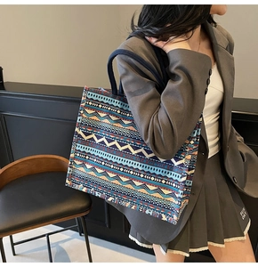 Detail of large canvas tote bag with bohemian geometric patterns and woven handles