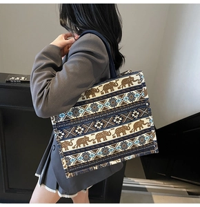 Detailed shot of large bohemian tote bag with elephant prints and navy straps