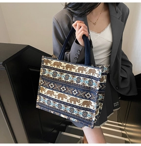 Detailed macro view of ethnic elephant print and geometric patterns on canvas tote bag