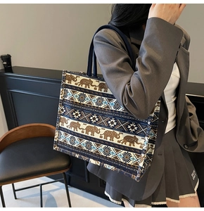 Detail of bohemian tote bag featuring elephant patterns and geometric prints on canvas