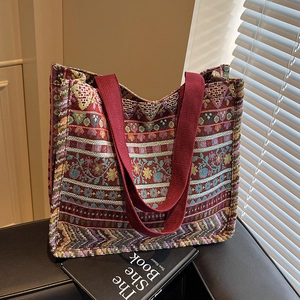 Ethnic bohemian tote bag with colorful geometric woven patterns and red handles