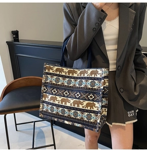 Detail of bohemian canvas tote bag with vintage elephant print and multi-layer patterns