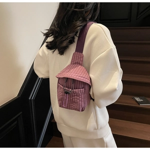 Detail of purple plaid crossbody bag with drawstring pocket and adjustable strap