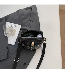 Detail view of the spacious inner compartment of the stylish colorblock crossbody bag