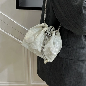 Elegant white drawstring bucket bag with butterfly embroidery and pearl chain strap