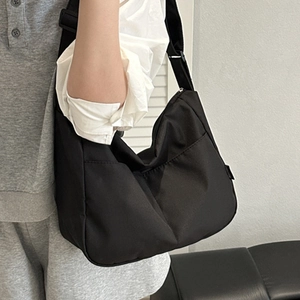 Minimalist black canvas bucket bag for women with wide strap for casual daily commuting