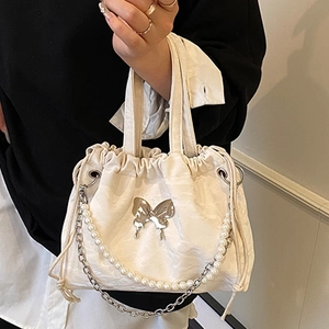 White pleated backpack with silver butterfly charm and pearl chain decoration