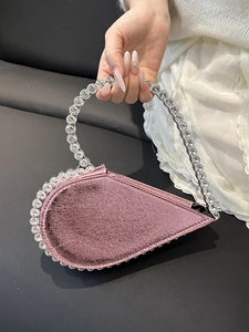 Pink heart-shaped handbag with sparkling rhinestones and elegant circular handle
