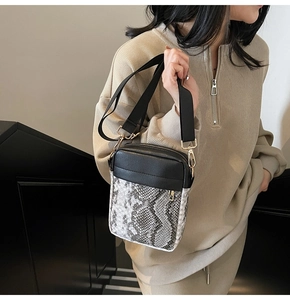Detail of the high-quality snakeskin pattern texture on this modern contrast crossbody bag