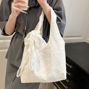 Elegant white floral lace tote bag with bow detail for women in a mirror selfie view