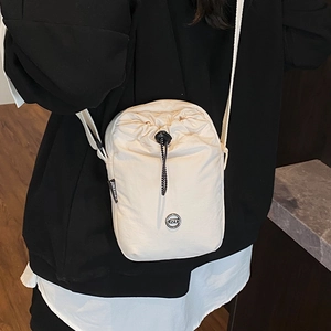 Chic off-white nylon drawstring crossbody bag for women with adjustable straps