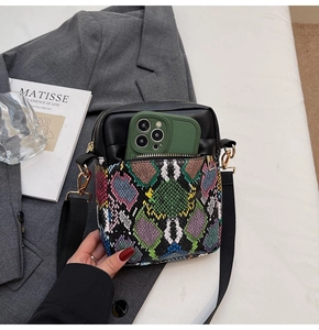 Detail of snake skin pattern handbag with external pocket for smartphone storage