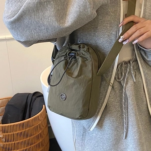 Olive green waterproof nylon crossbody bag with drawstring closure and JZO logo for women