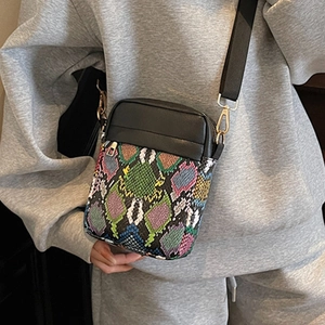 Chic snake print crossbody phone bag with black leather trim and wide textile strap