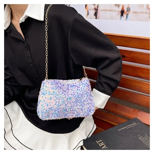 Détail d'un petit sac bandoulière à paillettes irisées avec une bandoulière dorée