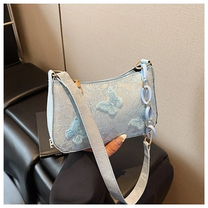 Detail of light blue lace tote with butterfly embroidery and acrylic chain strap