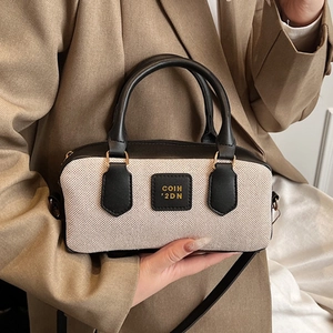 British style retro beige woven Boston bag with black leather trim and shoulder strap