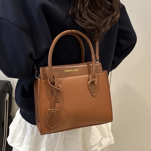 Elegant brown pebbled leather tote bag with top handles and Fashion & Bags gold lettering