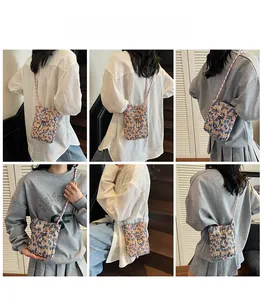 Detailed views of floral print crossbody phone bag with drawstring closure and braided strap