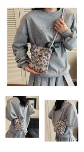 Close-up of floral fabric crossbody bag with rope strap and drawstring closure