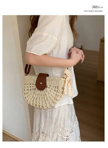 Detail of woven straw shoulder bag with leather flap and lace bow decoration