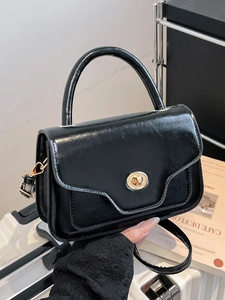 Glossy black patent leather handbag with gold metal clasp for modern women fashion
